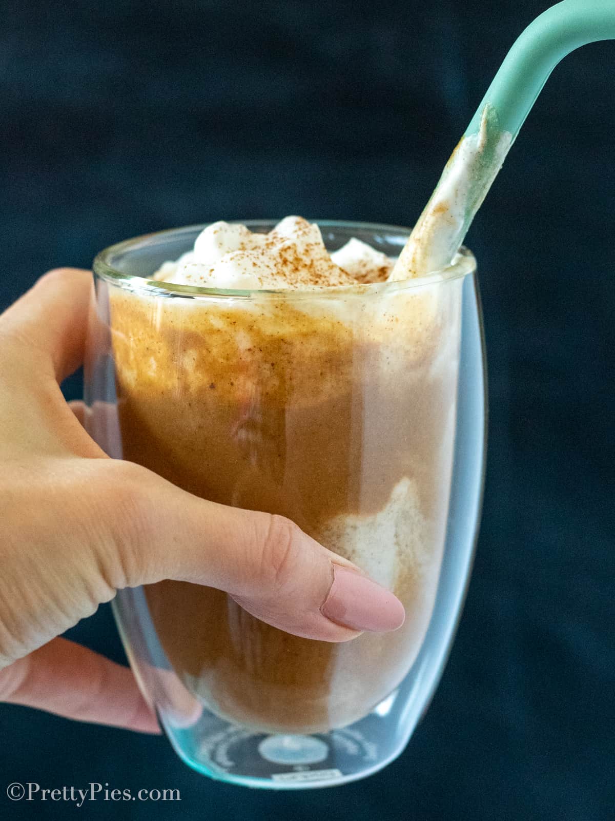 Hand holding clear glass withLow-Carb Pumpkin Frapp