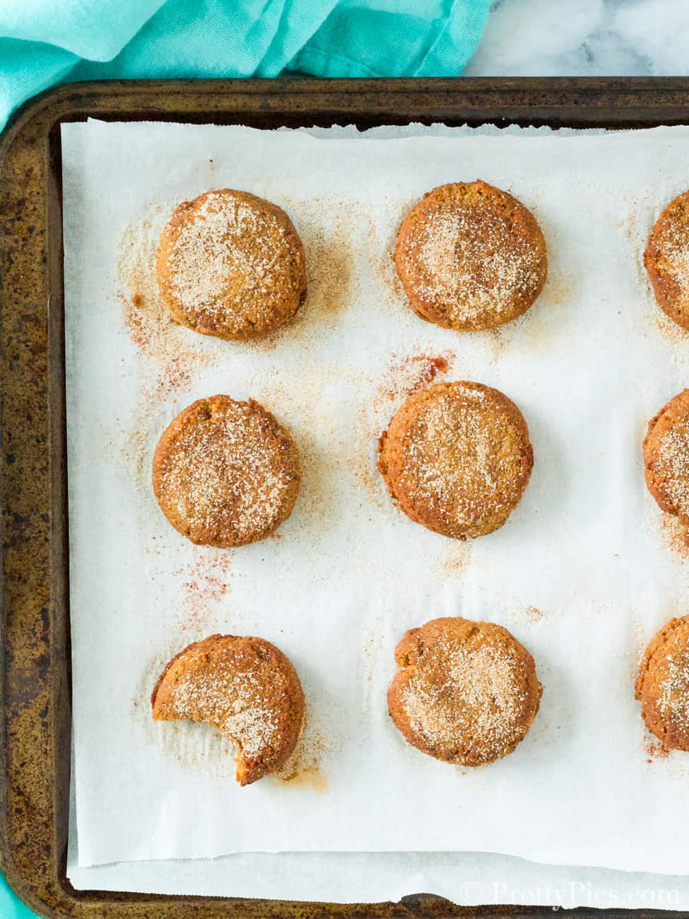 Baked snickerdoodle cookies on a cookie sheet