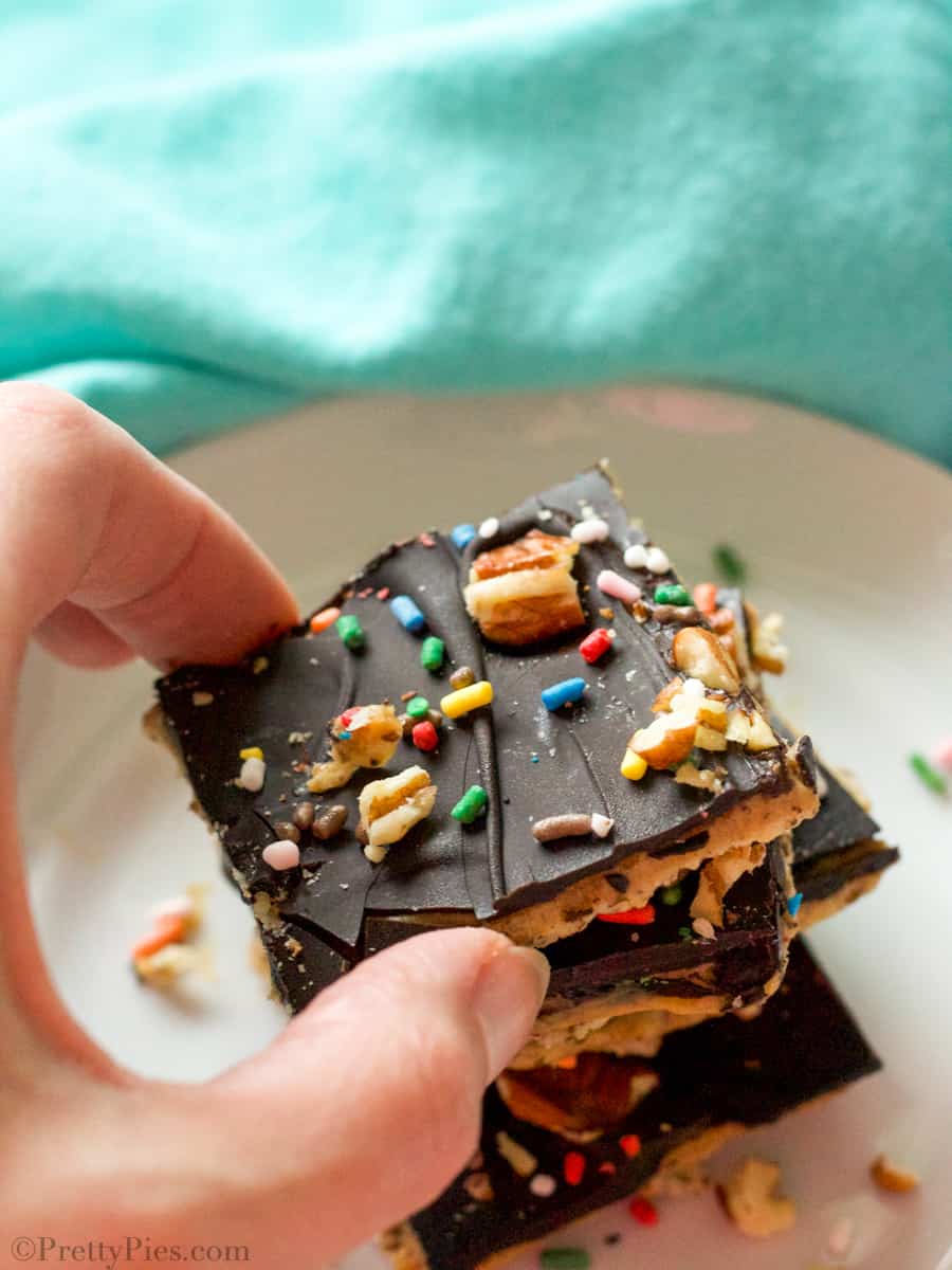 Low-Carb Christmas Cracker Candy -hand grabbing a piece