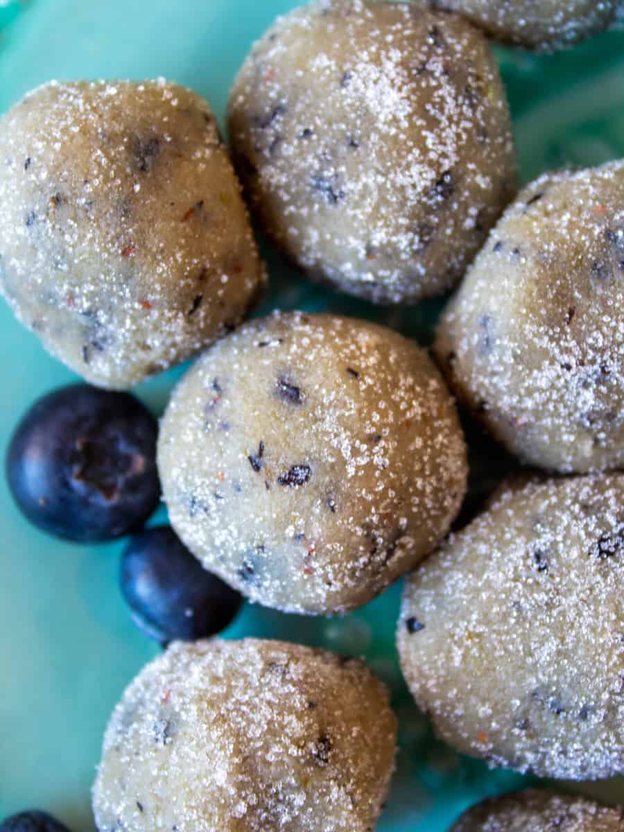 Close up overhead view of Low-Carb Blueberry Donut Holes with "sugar" coating